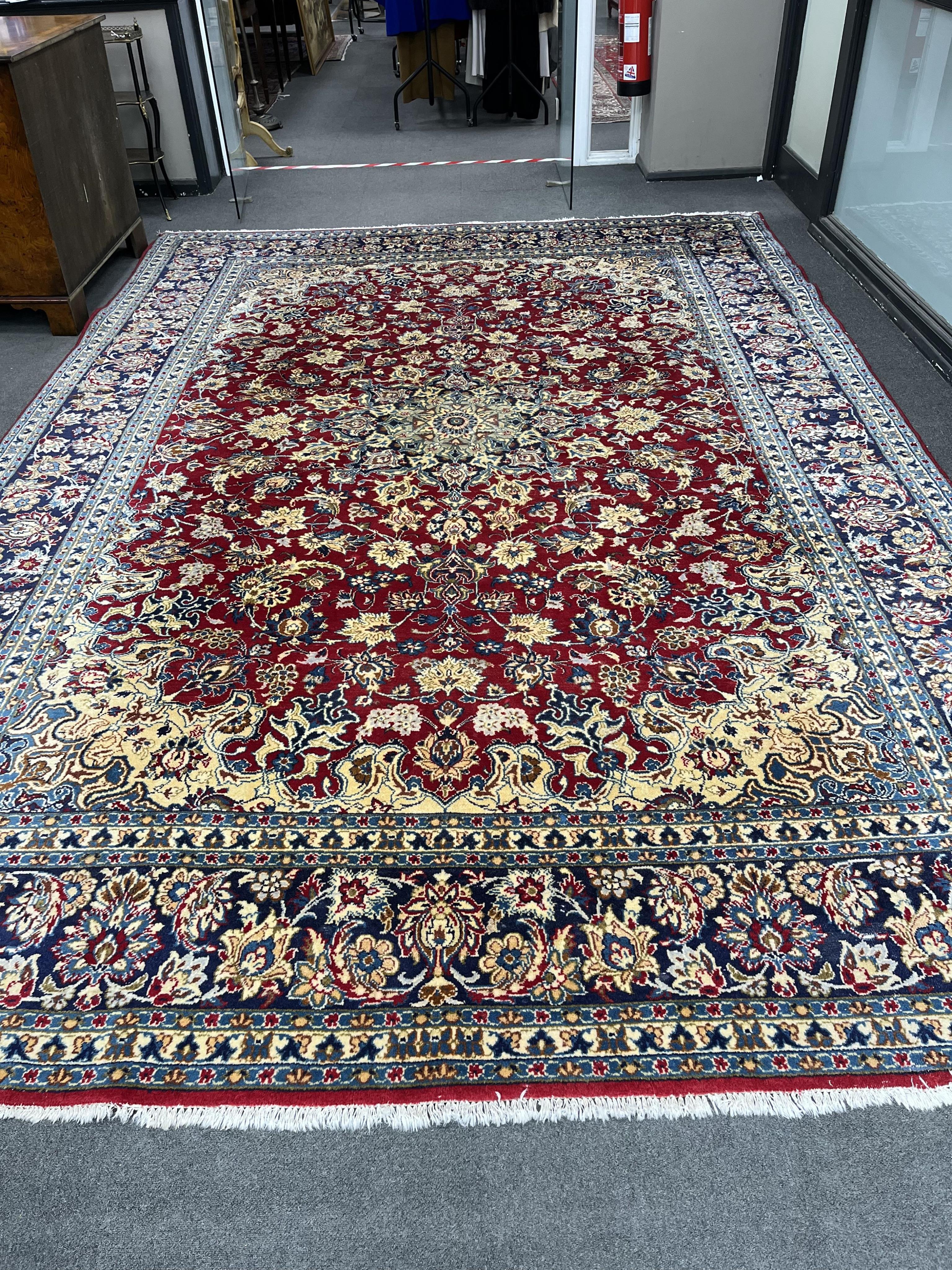 A Persian burgundy ground carpet, 410 x 282cm. Condition - good